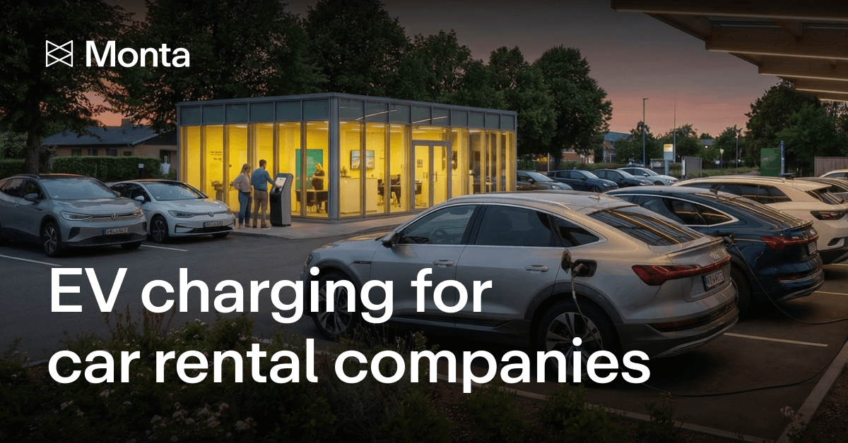 A modern charging station illuminated at dusk, with electric vehicles parked nearby and people using the facility.
