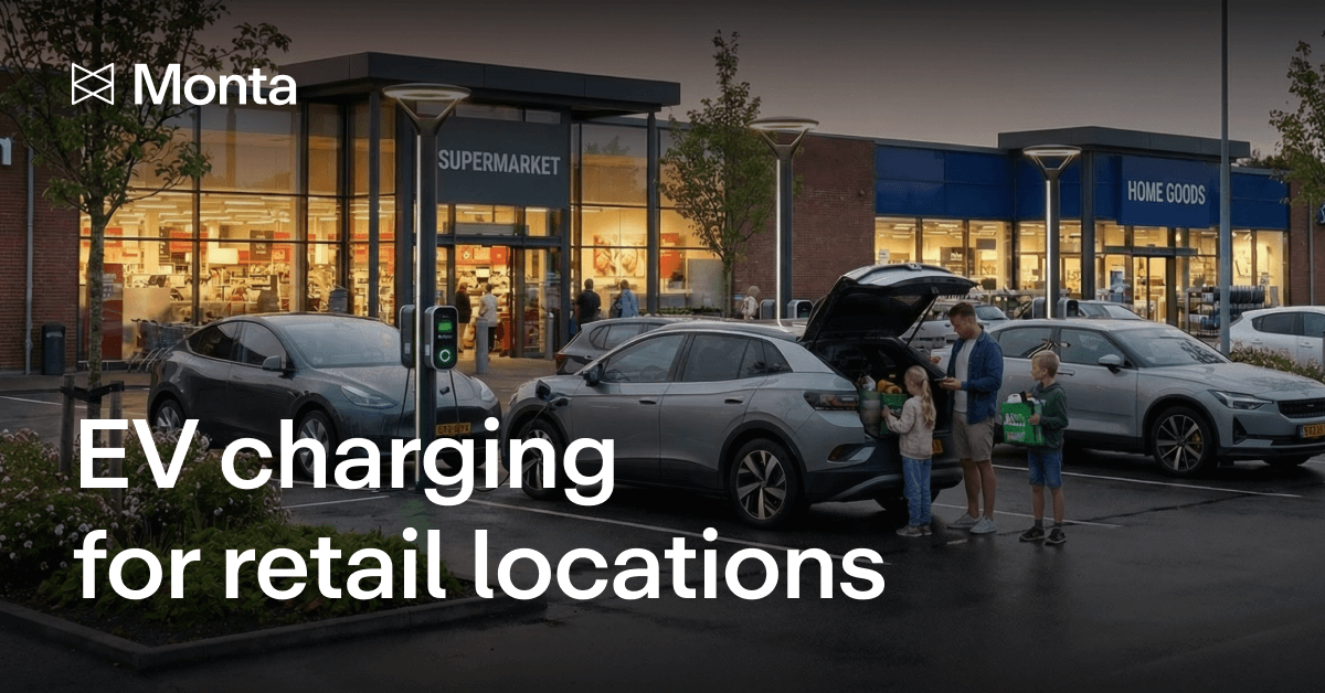A retail location with electric vehicle charging stations. Cars parked outside a supermarket and home goods store, under evening lights.