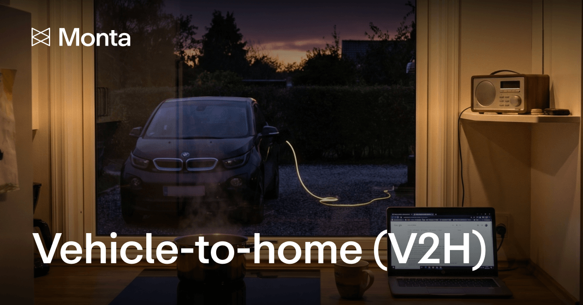 A dark kitchen scene showing a car charging outside at dusk, with a laptop on the counter, highlighting the V2H concept.
