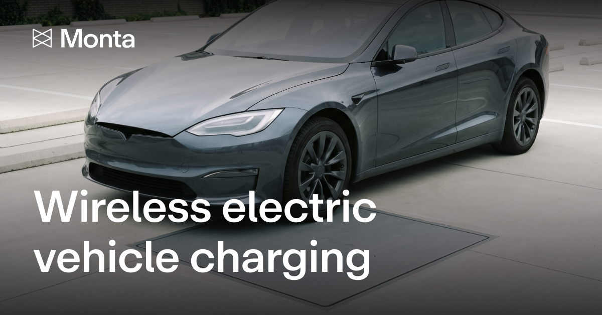 A grey saloon car parked over a floor-level charging pad, with the Monta logo and the text "Wireless electric vehicle charging".
