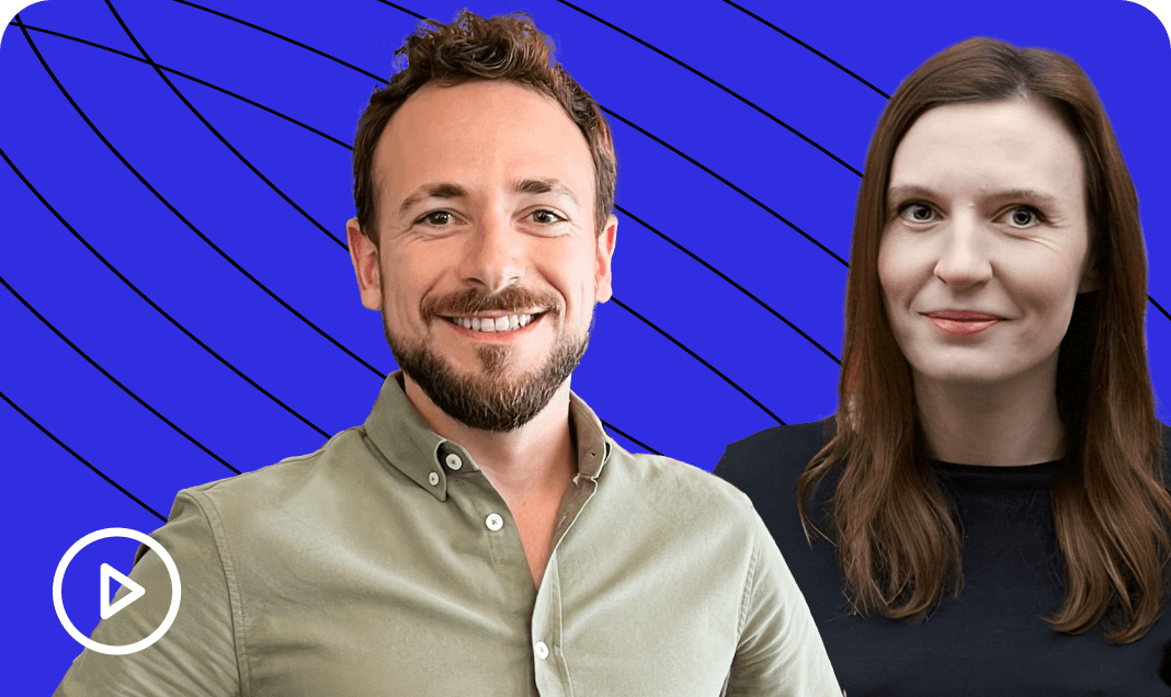 Two smiling presenters on a vibrant blue background with curved lines; one wears a grey shirt, the other a black top.